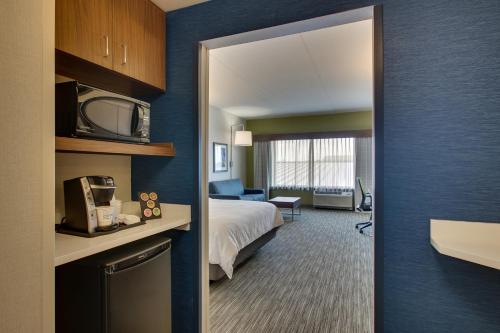 a hotel room with a bed and a television at Holiday Inn Express & Suites Findlay North by IHG in Findlay