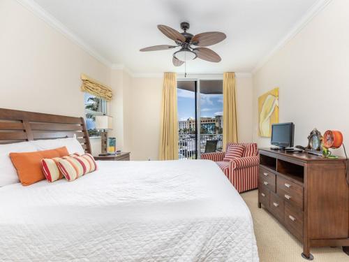 a bedroom with a bed and a ceiling fan at Waterscape A III in Fort Walton Beach