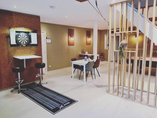 a living room with a table and chairs and a staircase at B&B Resort Tremele in Dreumel