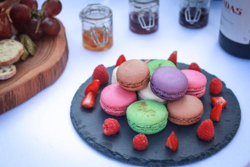 a plate of muffins and strawberries on a table at Keliki Luxury Lodge in Ubud