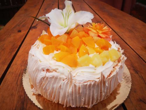 a cake with fruit on top of a wooden table at Agroturystyka Klęk in Stryków
