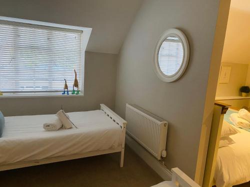 a small bedroom with a bed and a window at The Lodge at Broadway in Broadway