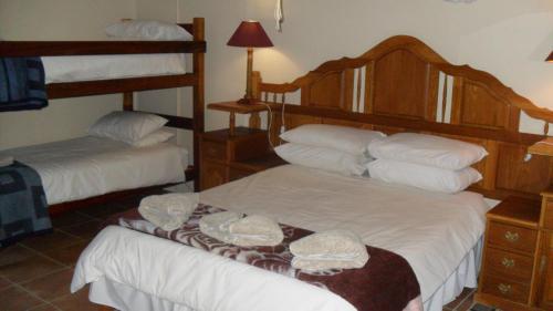 a bedroom with two bunk beds with white sheets at Seeheim Hotel in Seeheim