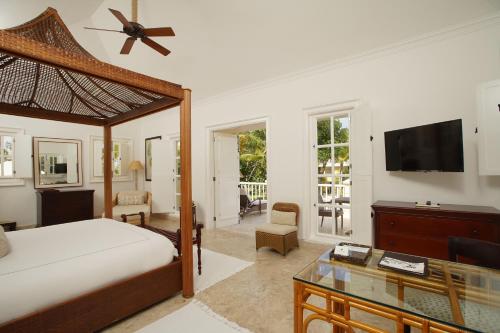 a bedroom with a bed and a flat screen tv at Tortuga Bay in Punta Cana