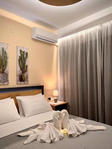 a bedroom with a bed with towels on the floor at Kolymbia memories house in Kolymbia