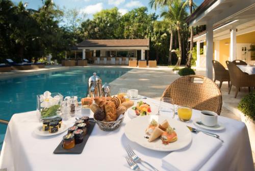 a table with food on it next to a pool at Tortuga Bay in Punta Cana