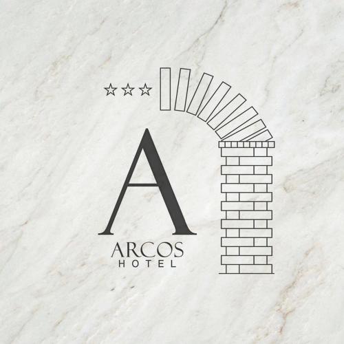 aacos hotel logo with a brick wall at Arcos hotel in Catemaco
