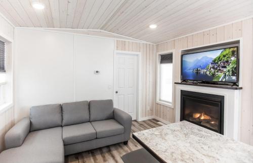 a living room with a couch and a fireplace at Boulder Mountain Resort in Revelstoke