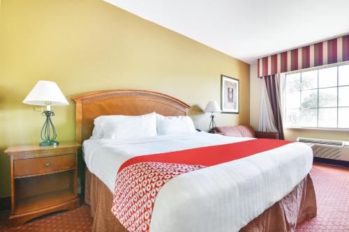 a hotel room with a large bed and a window at OYO Townhouse Oklahoma City Airport in Oklahoma City