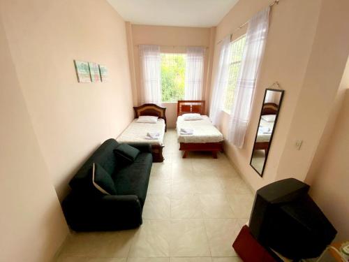 - un salon avec un canapé et une chaise dans l'établissement Villa Claudia - apartamento cómodo y tranquilo, à El Colegio