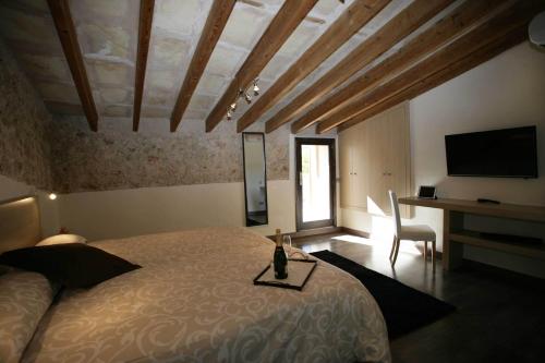 a bedroom with a bed and a desk and a television at Sa Posada in Porreres