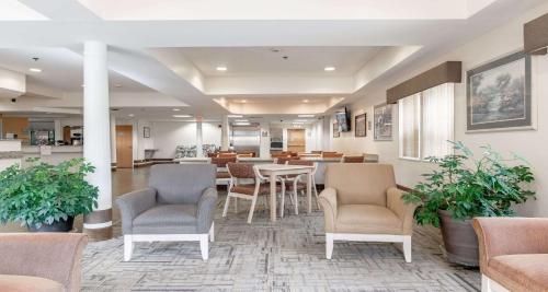a waiting room with chairs and tables in a building at SureStay Hotel by Best Western Christiansburg Blacksburg in Christiansburg