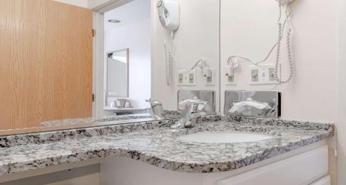 a bathroom with a sink and a mirror at SureStay Hotel by Best Western Christiansburg Blacksburg in Christiansburg