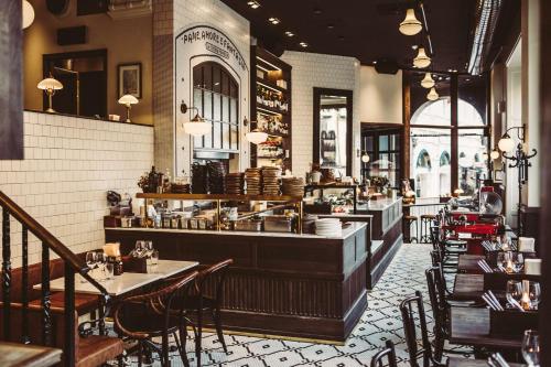 a restaurant with tables and chairs and a bar at The Vault Hotel, WorldHotels Crafted in Helsingborg