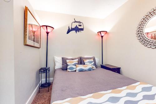 a bedroom with two floor lamps and a bed at Big Sky Ski Condo in Big Sky
