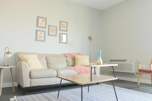 a living room with a couch and a table at Sleepover Premier Downtown Des Moines Apartments in Des Moines