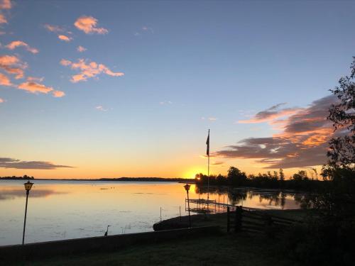 a sunset over a large body of water at Entire waterfront cottage in carrying place in Carrying Place