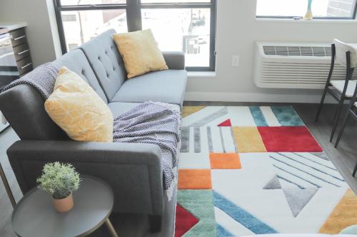 a living room with a couch and a table at Sleepover Premier Downtown Des Moines Apartments in Des Moines