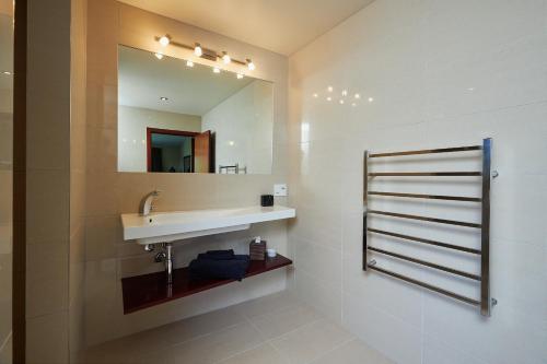 a bathroom with a sink and a mirror at Glencree Luxury Chalets in Kaikoura