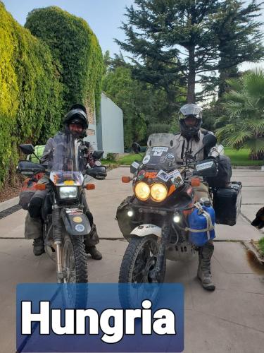 two people on motorcycles parked on a street at Quinta Ugarte in Ciudad Lujan de Cuyo
