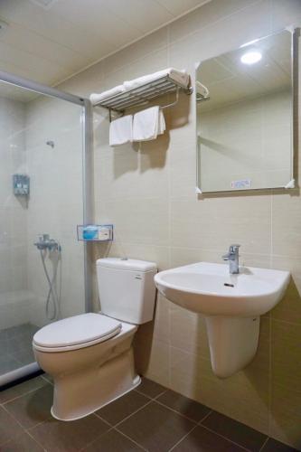 a bathroom with a toilet and a sink at Ｏn the road in Donggang