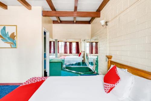 a bedroom with a bed and a boat in a room at OYO Oasis Motel Las Vegas I-15 in Las Vegas