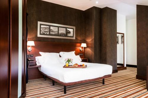 Un ou plusieurs lits dans un hébergement de l'établissement Hotel Granda
