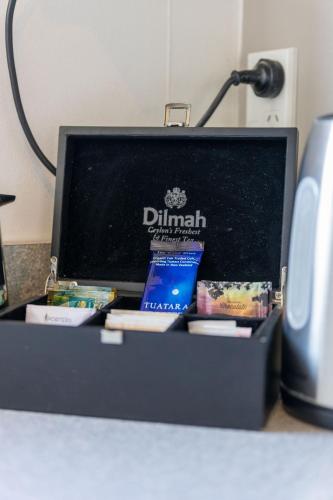 a box of dhmaband sitting on a desk at Kings Gate Motel in Nelson