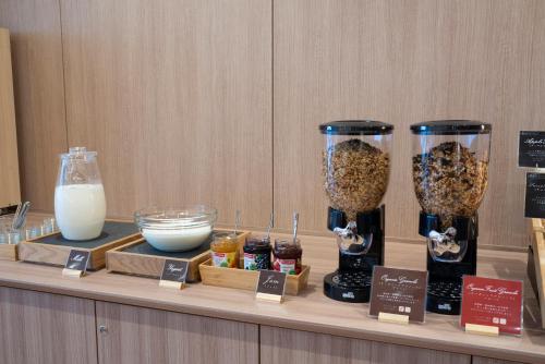 a counter with three glass containers of cereal and milk at Washington R&B Hotel Nagoya Ekimae in Nagoya