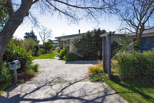 a house with a driveway next to a house at Magnolia House in Blenheim