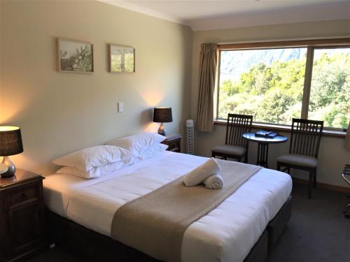 a hotel room with two beds and a television at Aoraki Mount Cook Alpine Lodge in Mount Cook Village