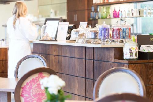 a woman standing at a counter in a store at Champneys Tring in Tring