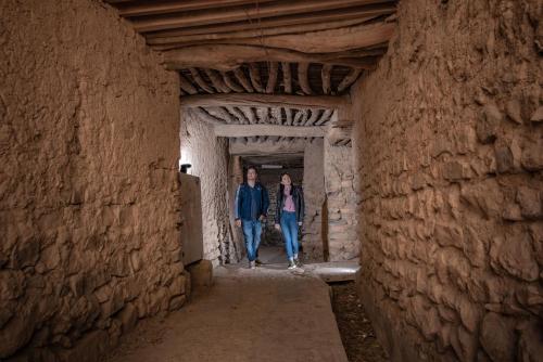 a man and woman walking through an alley at Sahab Resort and Spa, Jabal Al Akhdar in Al ‘Aqar