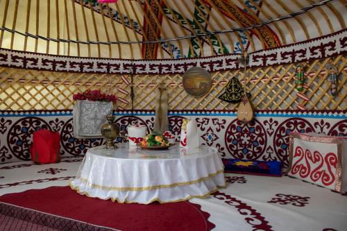 a room with a table in a yurt at Hotel Zhambyl in Taraz