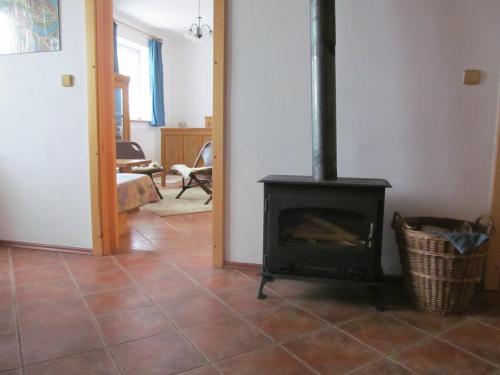 a living room with a stove in a room at Pension Otěvěk in Trhové Sviny