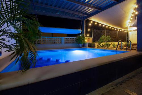 a swimming pool at night with lights around it at Hotel Samanu in Sayulita