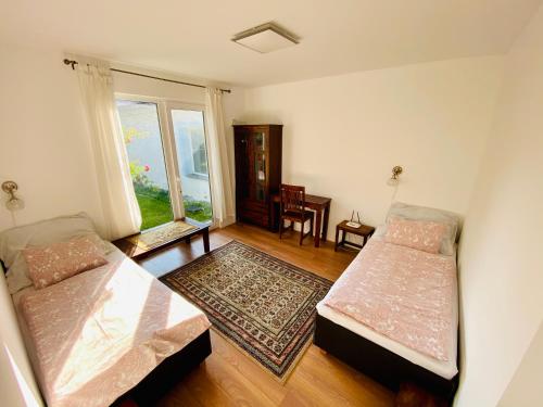 a living room with two beds and a window at Pension Julia in Banka
