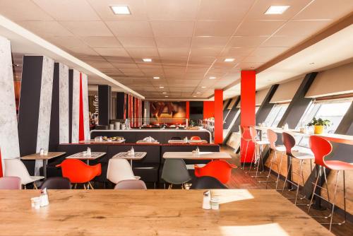 a large room with a large table and chairs at Ibis Graz in Graz