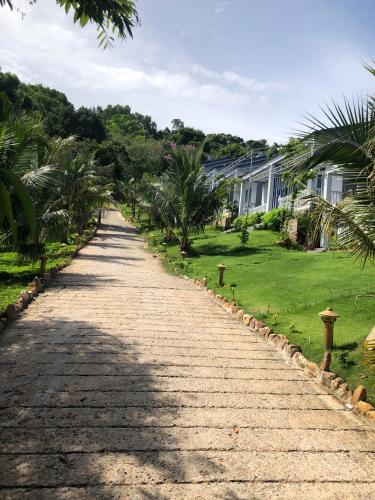 a cobblestone road in front of a house at BIỂN ĐỒI Bungalow in Phu Quoc