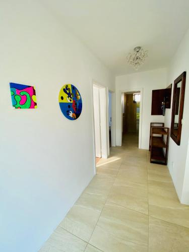a hallway with white walls and a tile floor at Pension Julia in Banka