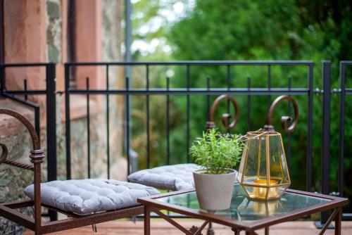 a glass table with a plant and a lantern on a patio at Schlosshotel Braunfels & Himmelreich in Braunfels