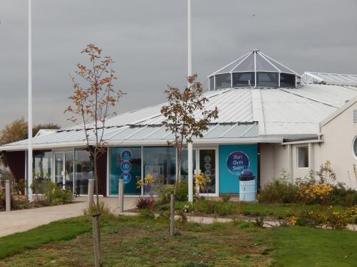 a white building with a roof on top of it at Flamingo Land - Cedar Wood CW49 in Kirby Misperton