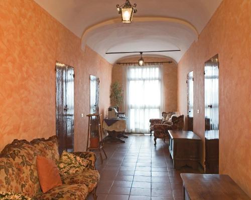 a living room with a couch and a table at B&B Acetaia Il Mulino Di Navicello in Modena
