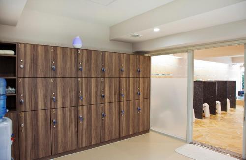 a closet with wood paneling and a glass door at Hotel Palm Royal Resort Kokusai Street in Naha