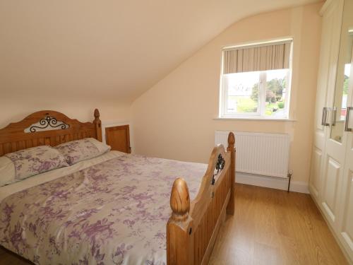 a bedroom with a large bed and a window at Loughanure Lake View in Annagry