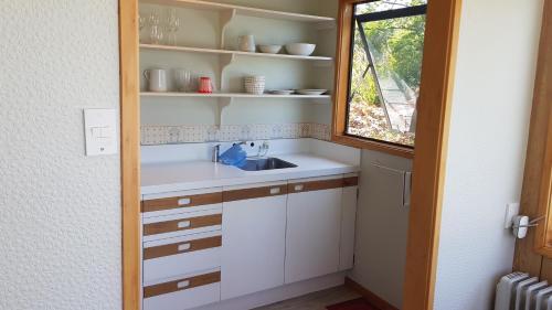 a small kitchen with a sink and a window at Champion Road Studio in Stoke