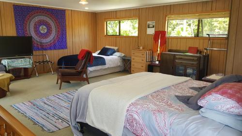 a bedroom with two beds and a tv in it at Champion Road Studio in Stoke