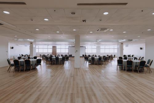 a banquet hall with tables and chairs in a room at Domotel Kastri in Athens