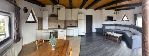 een woonkamer met een bank en een tafel bij Apartament Ella in Rîşnov