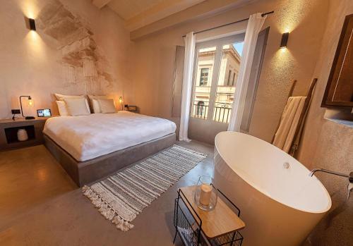 Casa Nostra Boutique Hotel & Spa في باليرمو: حمام به سرير وحوض استحمام ومغسلة